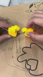 Video showing yellow frog fidget keychain with croak sound and LED light