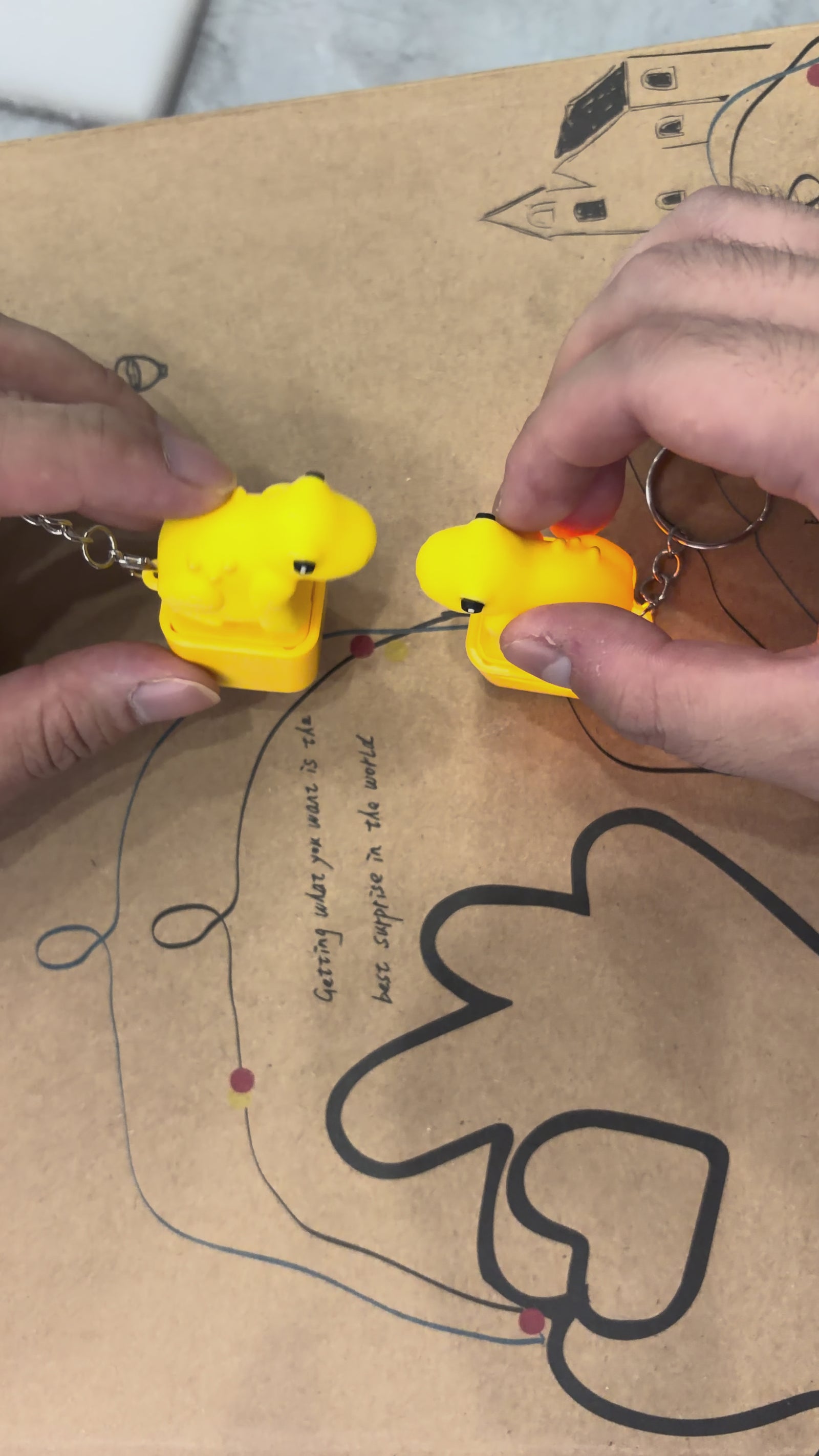 Video showing yellow frog fidget keychain with croak sound and LED light